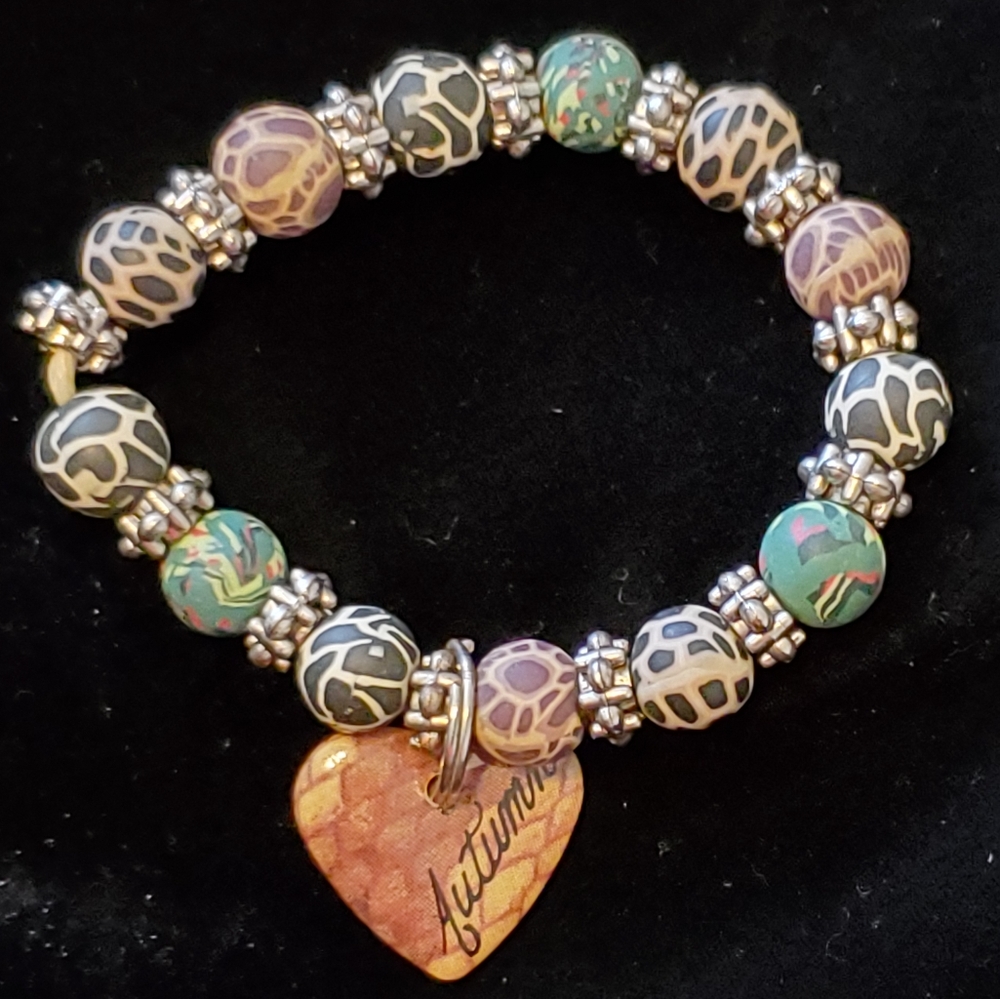 Boho animal print beaded stretch bracelet with heart that says "Autumn"